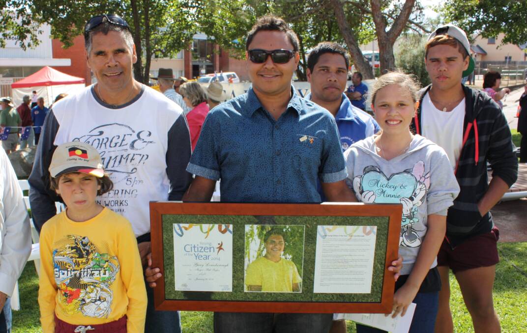 Gary Lonesborough (middle) shows off his 2014 Bega Valley Shire Young Australian of the Year Award at the Australia Day ceremony in January. He is pictured with his family. 