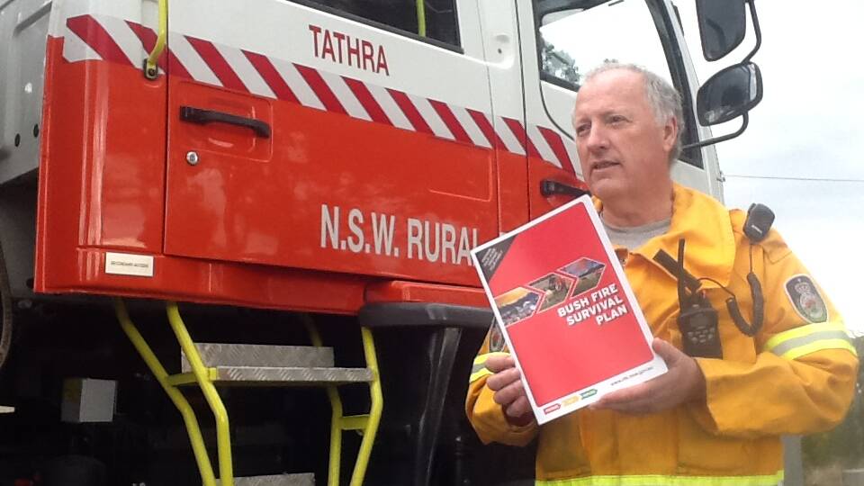 Tathra RFS Deputy Captain Lance Hartley displays the RFS bushfire planning booklet now available online, at the station or as a mobile phone app.