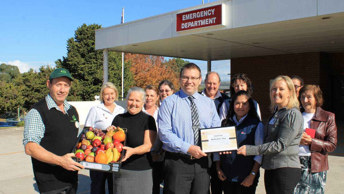 Bega Woolworths produce manager Pat O’Connell (left) presents Bega Hospital’s integrated service manager Wendy Grealy with a fruit tray, while the hospital’s director of nursing and midwifery Nicole Tate (right) presents Bega Woolworths store manager Matt Jorgensen with a certificate of appreciation.