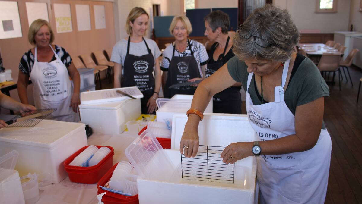 Pauline Wellington (right) takes part in a soft cheese-making workshop in Bega's Anglican Church hall on Tuesday.