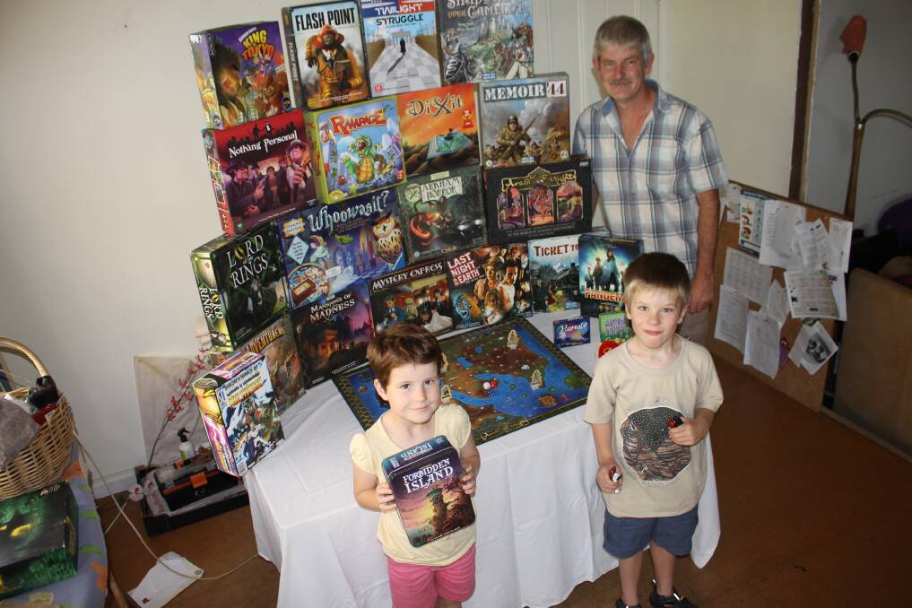 Bega Board Game member Simon Clark (right) and his children Phoebe and Jasper get set for International Tabletop Day on Saturday.