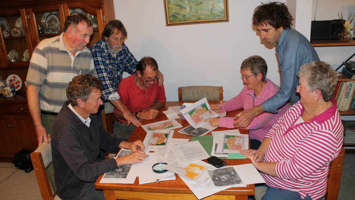 Looking over council planning documents and zoning maps are Coolagolite residents (clockwise from left) Jeff Brown, Bill Vipond, Mark Fowler, Peter Ryall, Danie Ondinea, Jake Smith and Nina Vipond.