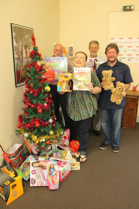 Admiring the growing pile of presents under the BDN Toy Drive Christmas tree are BDN features coordinator Gary Etcell, Salvos Lieutenant Lesley Newton, Bega Rotary president Charlie Blomfield and Bega Vinnes’ Tony Hergenhan.