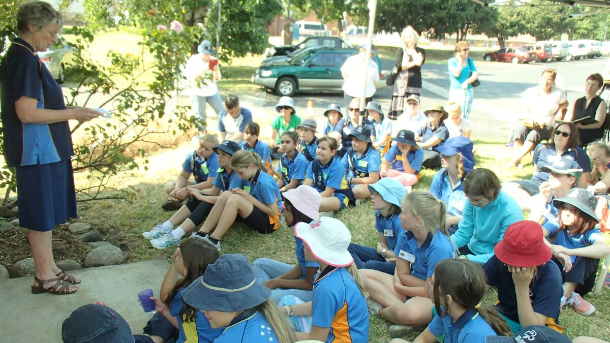 Current Bega Girl Guides and their families take part in the time capsule recovery ceremony.