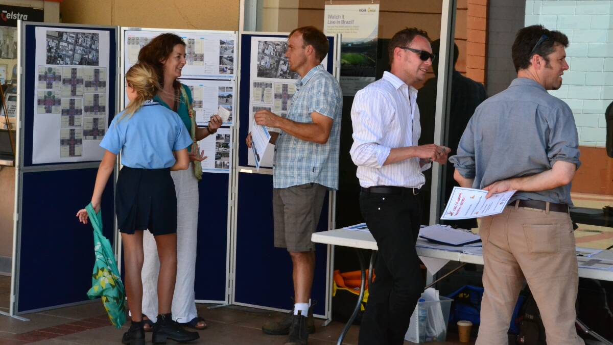 Representatives from the Bega Valley Shire Council and Spiire discuss landscape master plans with interested Bega locals.