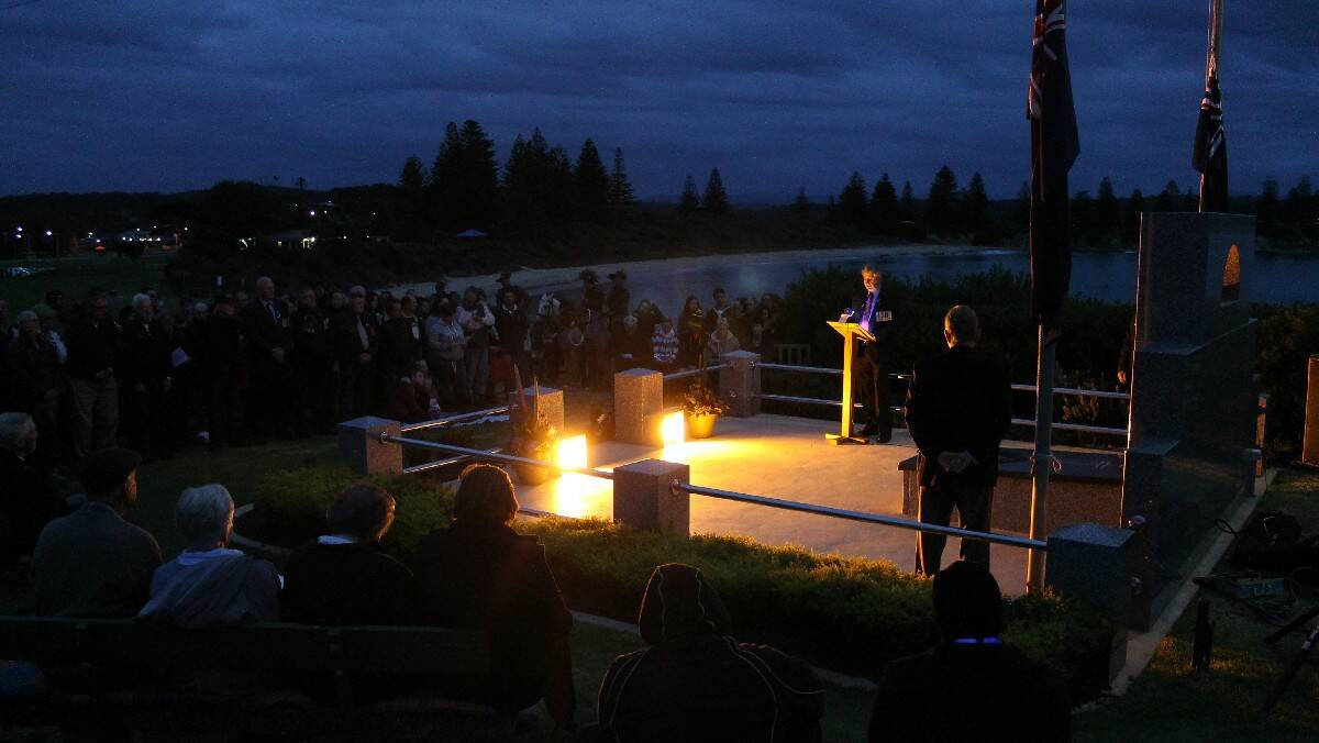 The crowd at the Bermagui Anzac Day dawn service listen quietly to the proceedings.