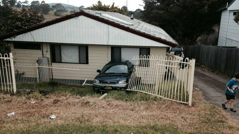 A car comes to rest in a Fairview St home's front bedroom.