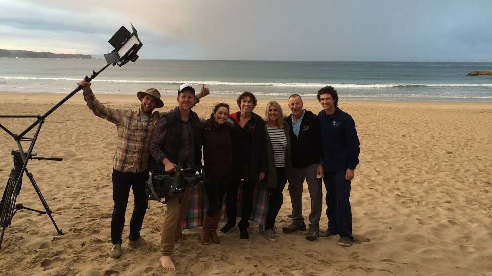 Gary, Jo and Sam Rodely of Tathra Oysters with the Sydney Weekender film crew and presenter Rosie Jacobs on Tathra Beach last week.