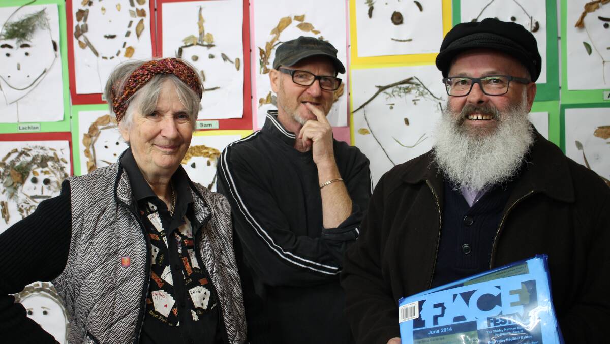 Anna Senior, Richard Maude and Chris Phillipps in front of artwork by St Patrick’s Primary School students in the ReArtVision space.