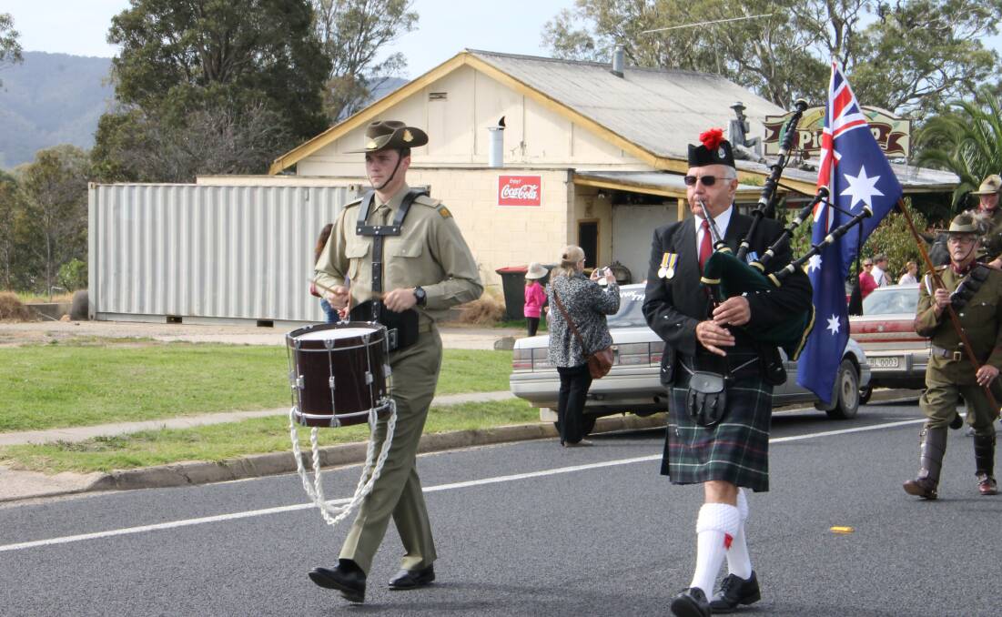 Officer cadet Jonathon Lowe and piper, retired Detective Inspector John Cross, lead the march at the Bemboka Anzac Day service.