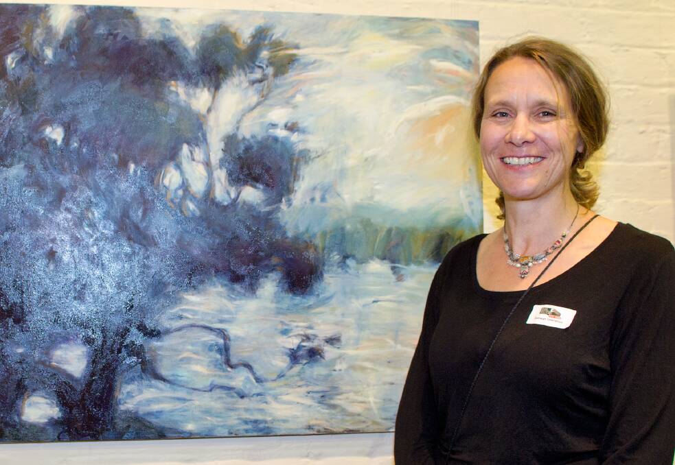 Raewyn Lawrence, People’s Choice runner-up, shows off her work in the Basil Sellers Art Prize, River Tree.