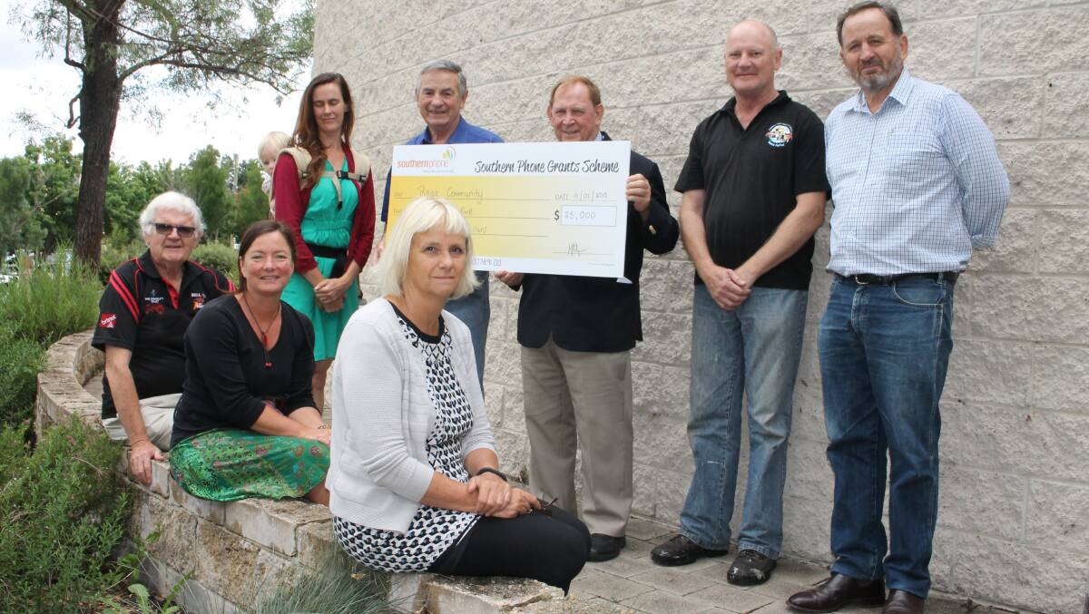 Southern Phone chairman Bill Hilzinger presents $25,000 to Bega Valley Shire Mayor Michael Britten, to be shared among nine community groups as part of a new Mayoral Grant initiative. Representing several of those groups are (back, from left)  Alicia Gauld from the Candelo Karate Dojo,  John Fraser from the Wolumla Memorial Gates Rededication Trust, Charlie Bell from the Bega Showground Trust, (front) Alex Nicol from the Bega Bombers Football Club and Michelle Richmond from the Pambula Wetlands and Heritage Project with BVSC general manager Leanne Barnes.