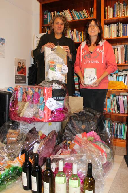 
Gabrielle Powell and Laura Wilcox with some of the prizes available in the Women’s Resource Centre raffle.
