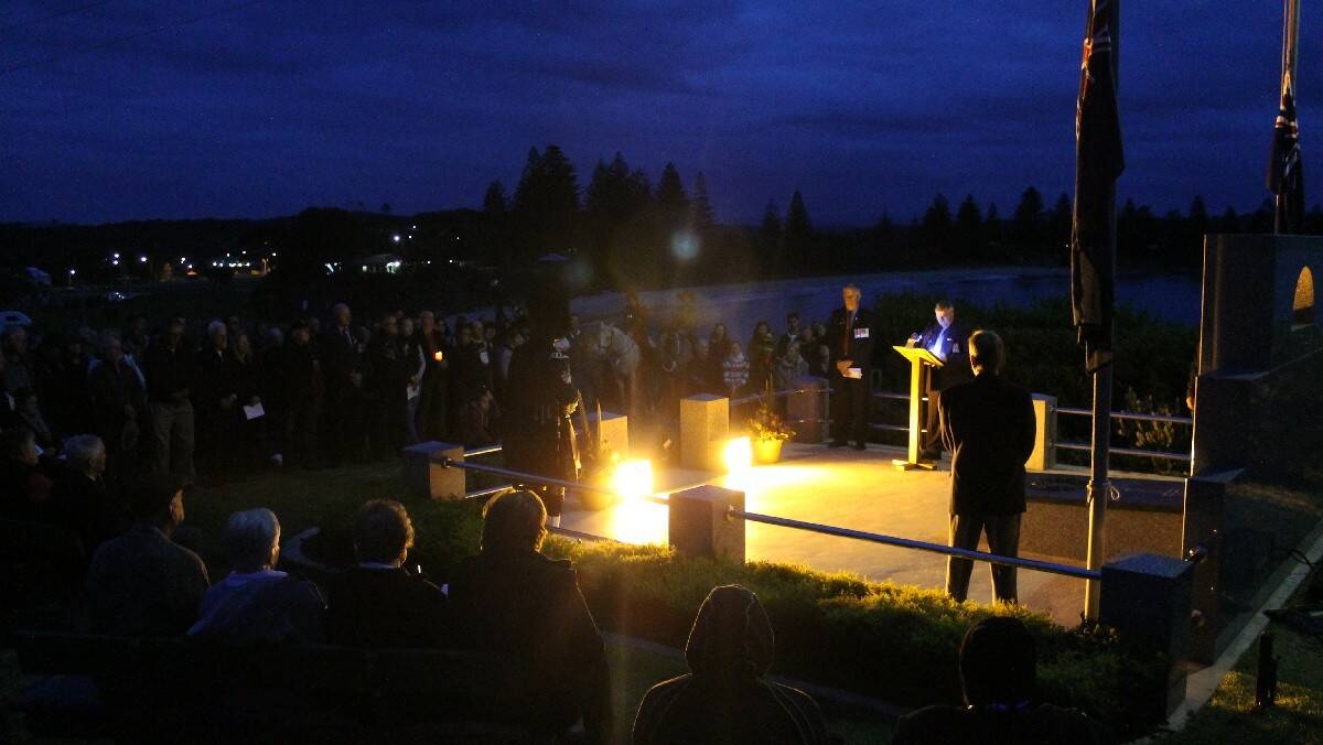 The crowd at the Bermagui Anzac Day dawn service listen quietly to the proceedings