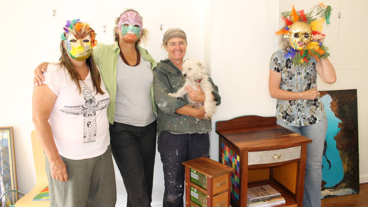 Among those helping to set up the International Women’s Day exhibition at Spiral Gallery yesterday are (from left) Robyn Williams, artist and training art therapist; Women’s Resource Centre coordinator Gabrielle Powell; woodwork artist Jo Saccomani (with four-legged friend Bowie) and WRC volunteer Rowena McConnell.