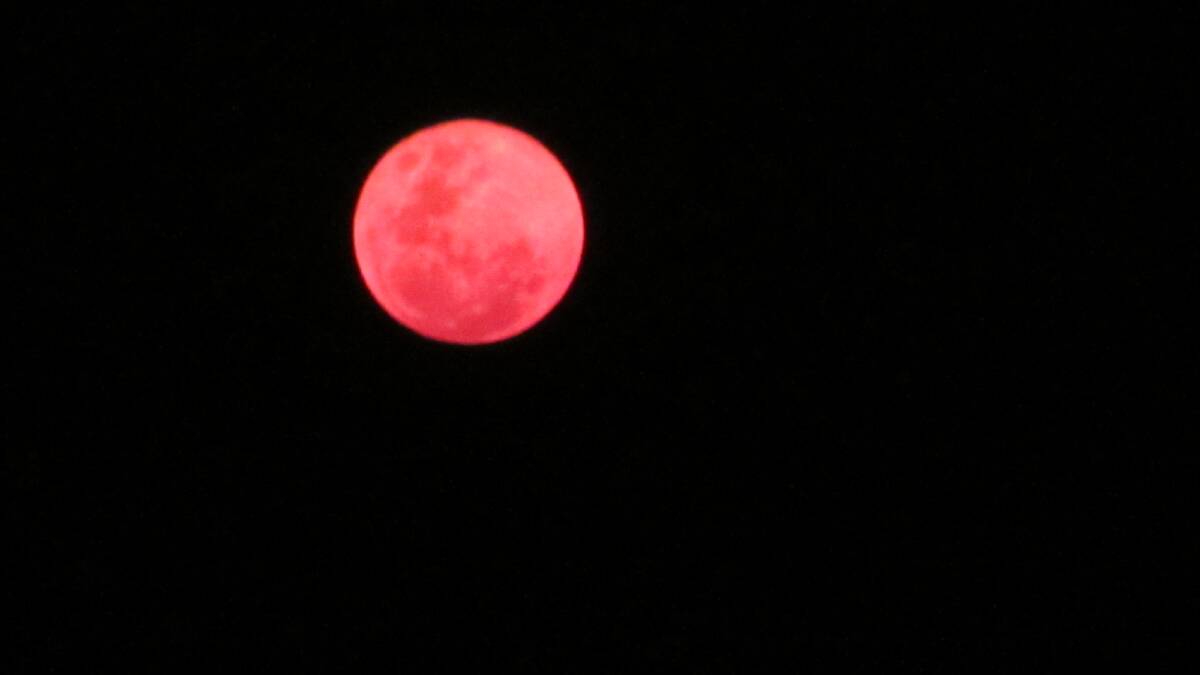 The moon isn’t  red only during an eclipse. This one was taken in October 2013 during the bushfires. Photo by Alison Moffitt of Angledale.