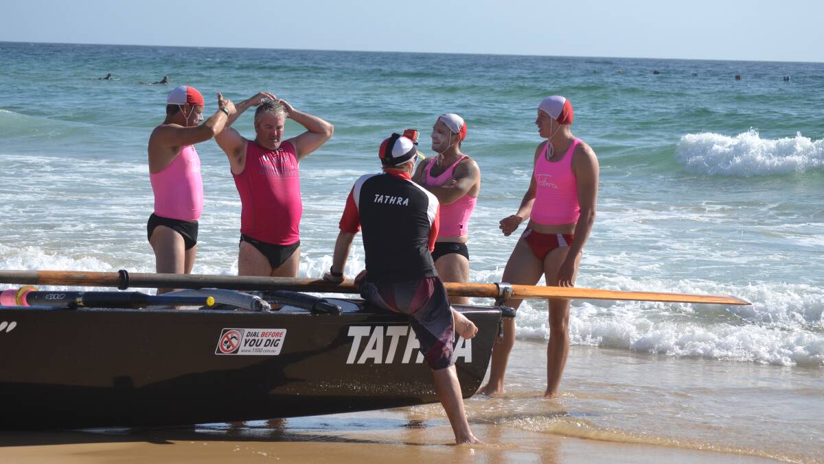 The Tathra men's surf boat crew talk tactics ahead of the Narooma carnival. They will be in action again on Saturday in their home surf.