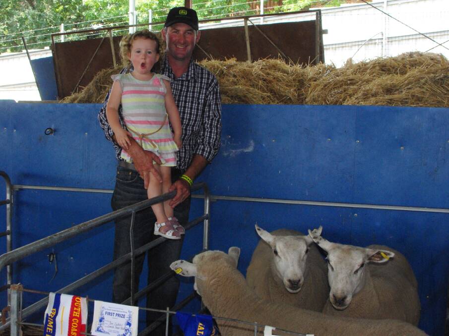 Tim Collins, holding Pippa, with Tim and Jo’s champion pen of three fat lambs.