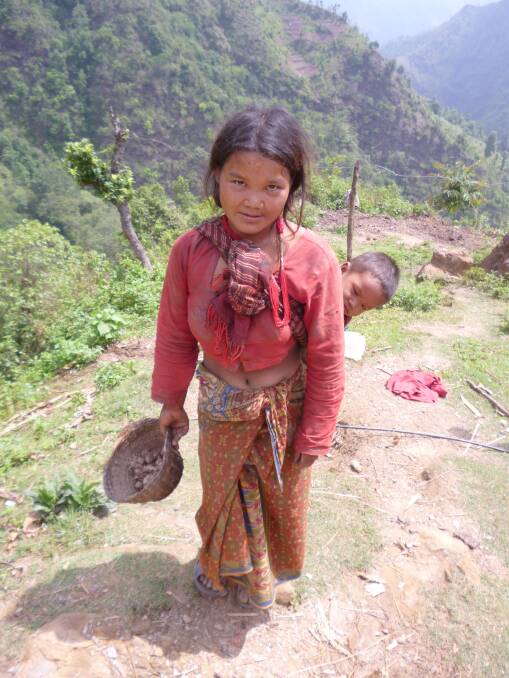 A Chepang Hill villager from an area who has received water tanks from Pebbles for Nepal. Women and children have to fetch and carry water every day in the region. 