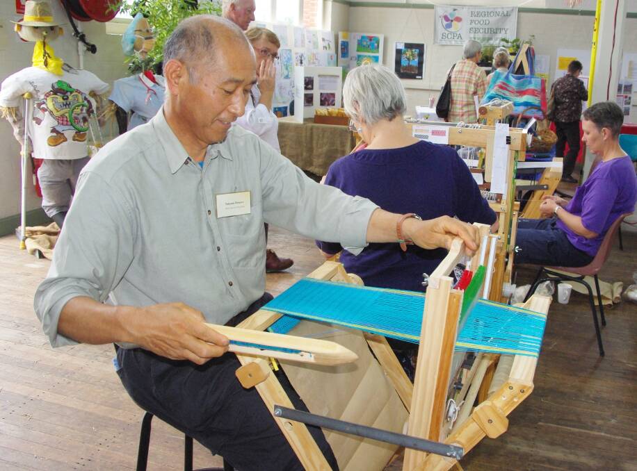 As part of the handicraft demonstration, Takumi Deneve at work at one of the looms he made.