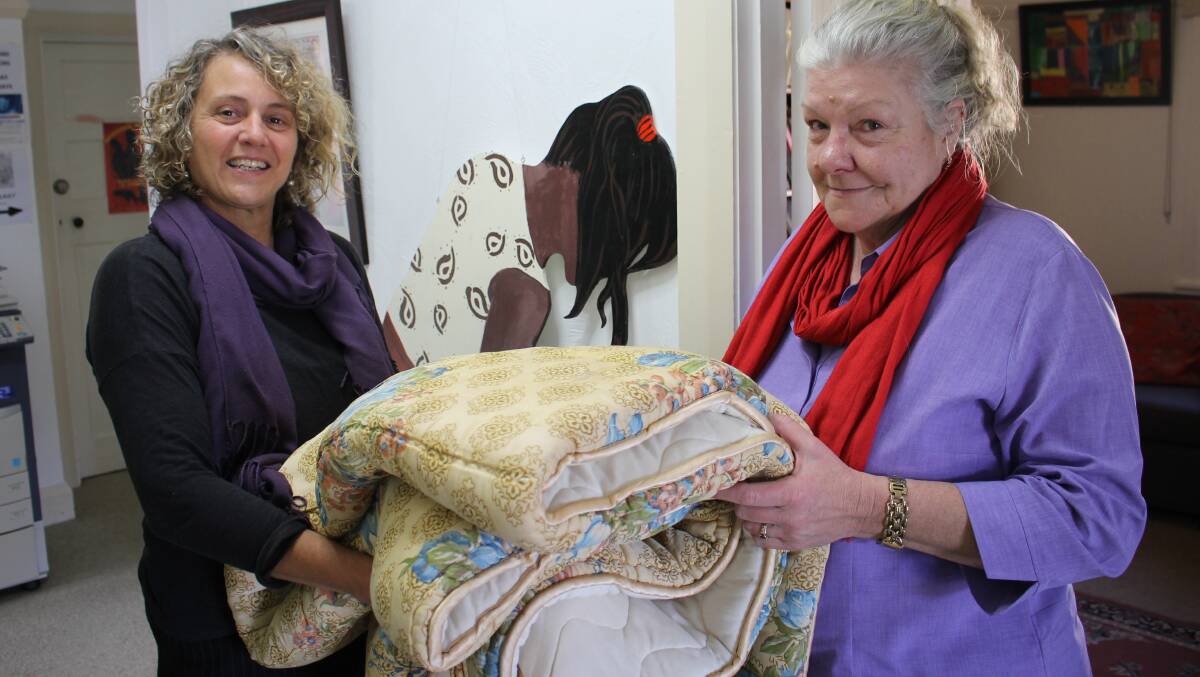 Gabrielle Powell (left) and Dianne Smithett of the Women’s Resource Centre with one of the blankets which has been donated towards people in need.