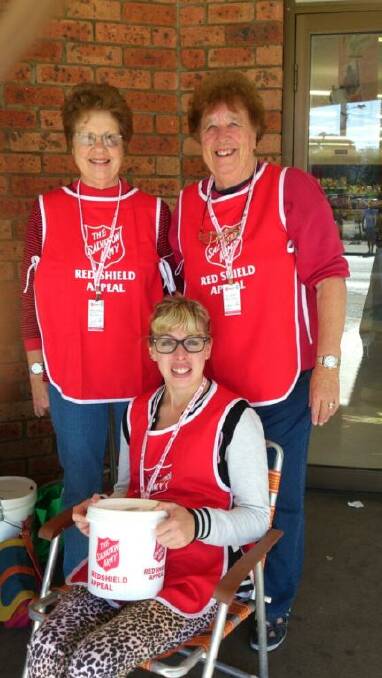 Robyn Calhoun, Mavis Salt and Cara Hay (seated) fundraising outside Merimbula Woolworths for the Red Shield Appeal on Sunday.