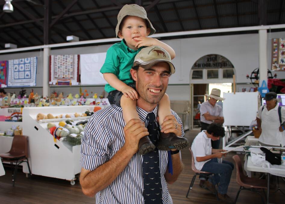 Nowra’s Tom Cochrane and his son Hayden, 19 months, inspect the pavilion exhibition at the Bega Show.