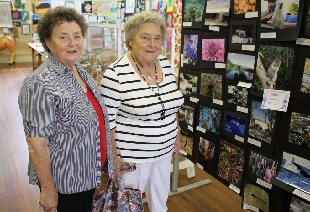 Sisters Betty Corby (left) and Joan Irvin, of Bega, check out the art exhibition at the Bega Show.