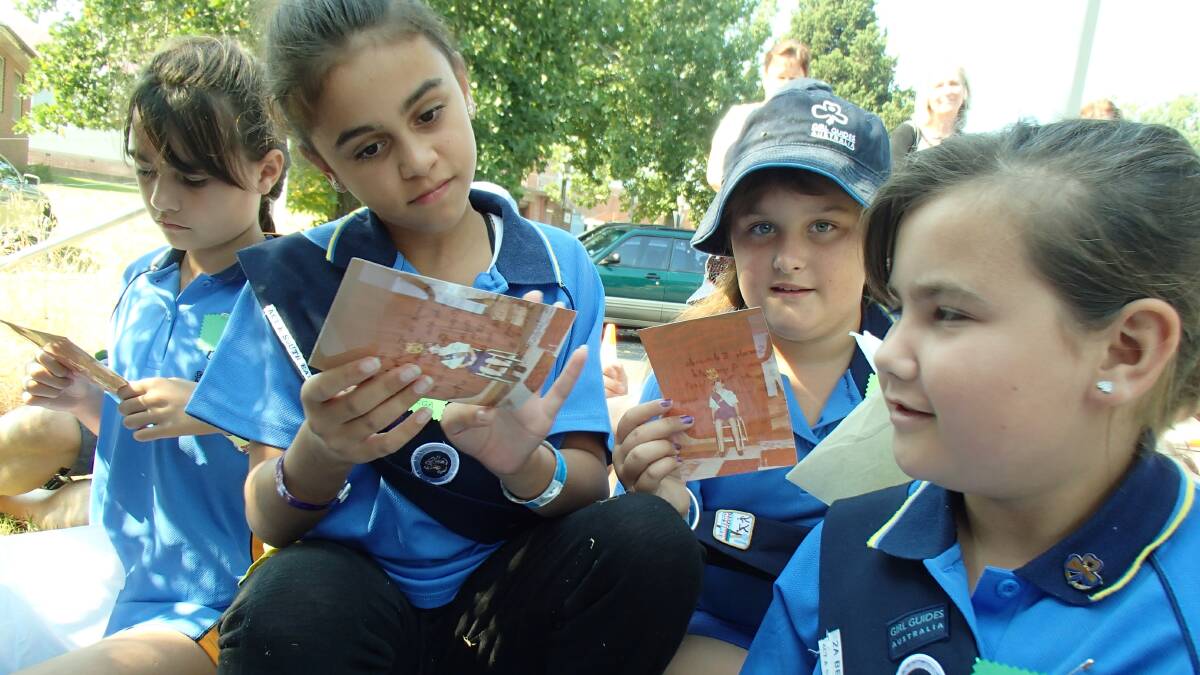 Current 2A Bega Guides Larissa Davis, Keyarni Luff, Ashtyn McLean and Phoebe Davis take a closer look at some of the photos from the time capsule.