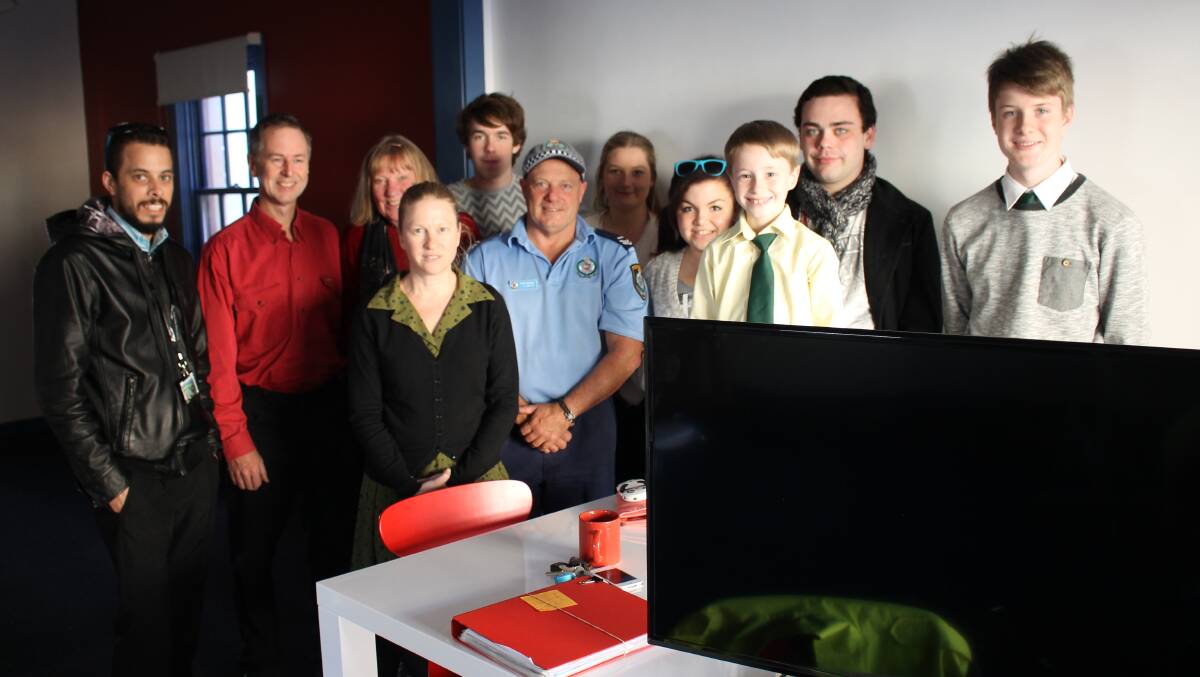 David Neyle (second left) donates a TV to Bega PCYC Senior Constable John Smith (centre) and members of the Bega Valley Youth Council. 