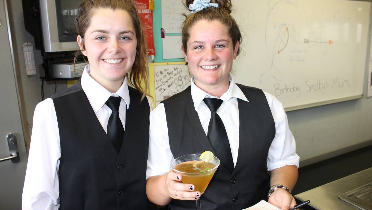 Ellie Walsh and Emily Pearce work as wait staff on Friday, taking orders and handing out mocktails to guests.