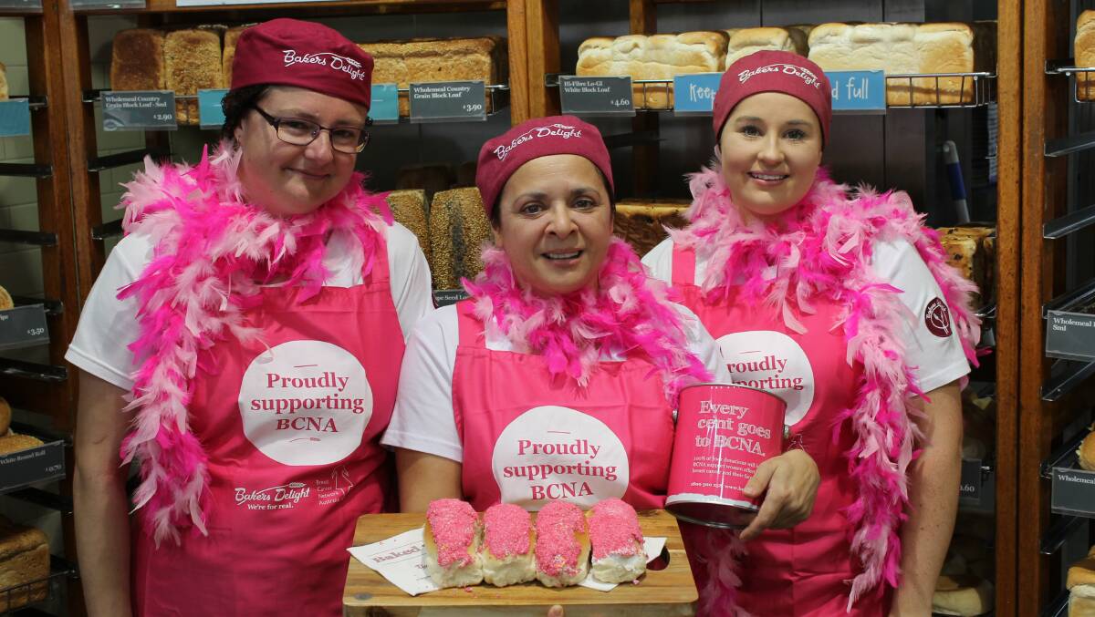 Nicole Underhill (left), Rosey Muzzi and Alicia Abraham with their pink finger buns and matching pink aprons for the annual Pink Bun fundraiser. 