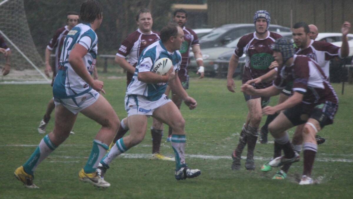 • Panther David Inskip charges headlong at the Tathra Sea Eagles during a deluge of rain recently. 