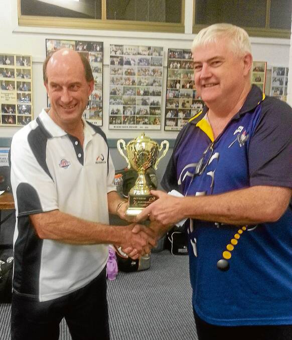 • Bega Squash Club president Dennis Curtis (left) presents ACT Masters vice-president Alan Martin with the Rashes trophy.