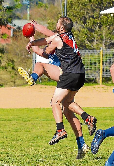 • Bega Bombers president Justin Welsford goes for a mark during a match against the Merimbula Diggers last year. 