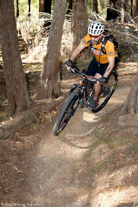 • Winter Warmer series sponsor John Stylianou of Tarra Volkswagen rounds a narrow corner during the first round of the mountain bike season on Saturday. 
Photo courtesy of Warren Purnell Photography. 