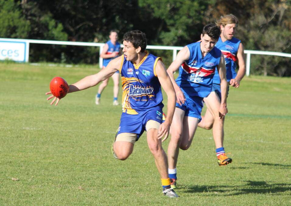 • Bermagui’s Luke Kingston gets a hand to the ball with two Merimbula Diggers in hot pursuit on Saturday. 