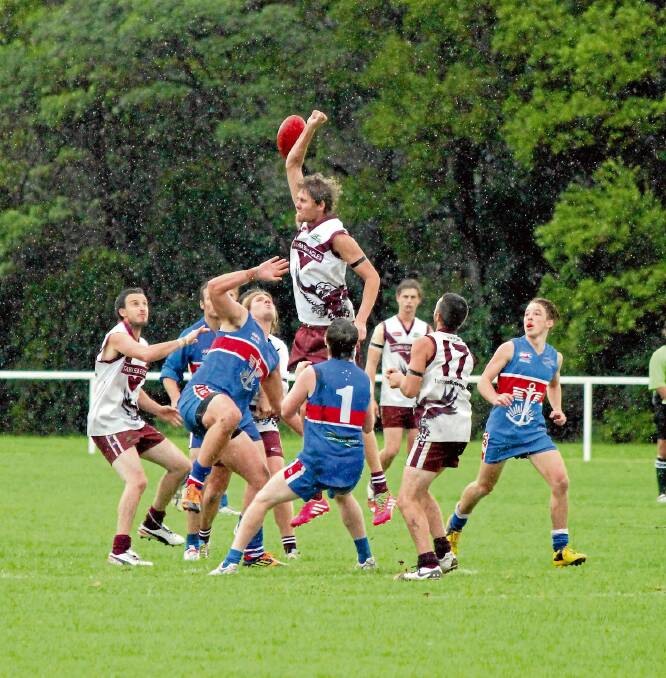 • The Tathra ruckman flies high to clear the ball to team-mates in the third quarter on Saturday. 