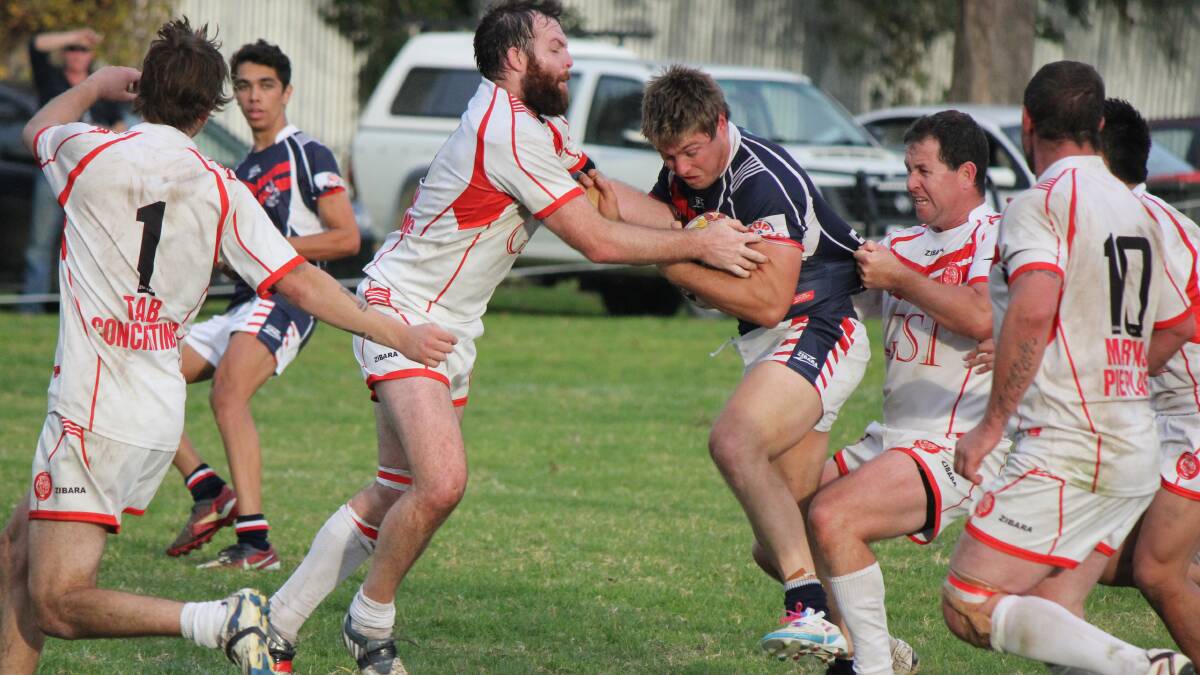 Roosters captain-coach Ryan Apps goes head on with Eden Tiger Greg Nicholson during the two clubs' previous encounter recently. Sunday's games were cancelled due to the weather. 