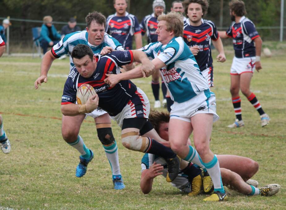 • Rooster Luke Hoskins gets dragged down by the combination of Wade Irvin, Jory Taylor and Jamie Glenn on Sunday during the Panthers 16-10 win over the Bega reserve grade squad. 