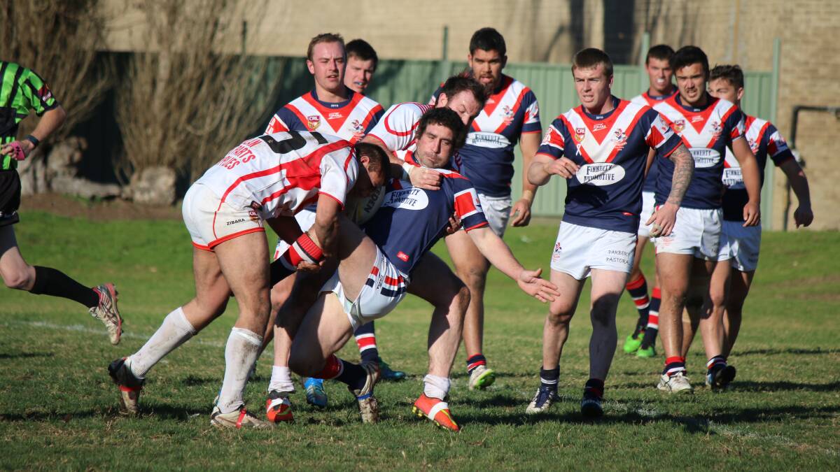 • Bega’s Scott Orr casually goes to ground in a two-man tackle by the Eden Tigers on Sunday. The Roosters were able to win 19-18 in golden point extra time. 