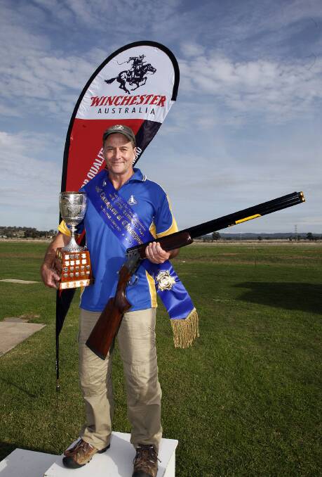 • Wayde Hawkins accepts the trophy for the Australian national champion of champions at the National Cup Titles in Wagga Wagga recently.