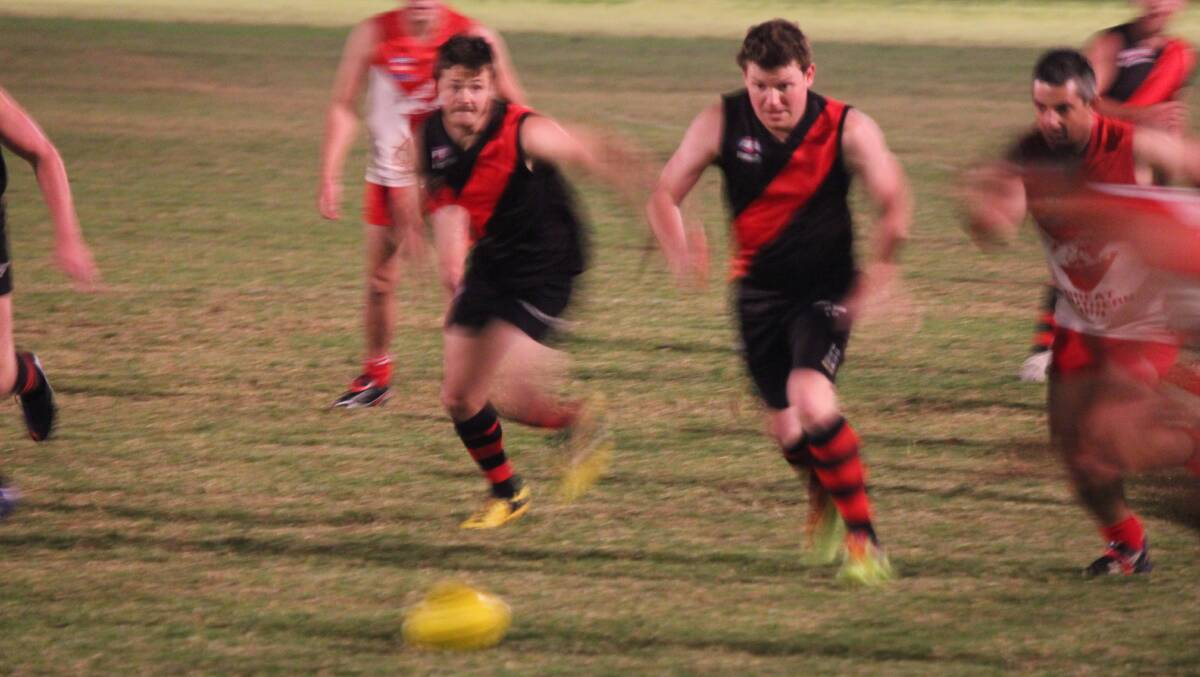 • Bomber Larry Fuller (right) runs on to the ball against the Eden Whalers on Friday night. 