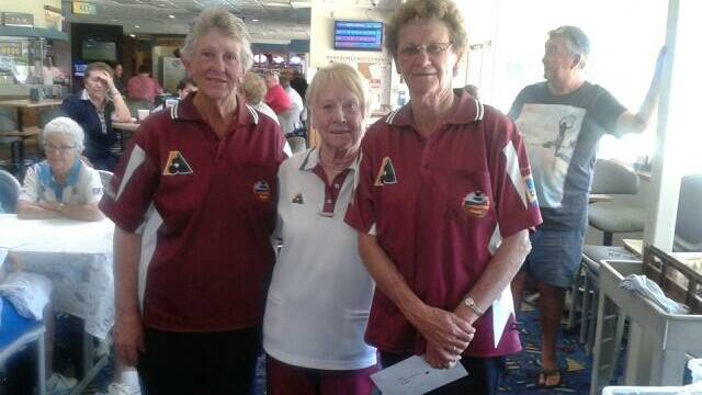 • Tathra ladies bowls president Maureen Sommerville (centre) congratulates classic pairs winners Lyn McMahon and Annabel Gammon.