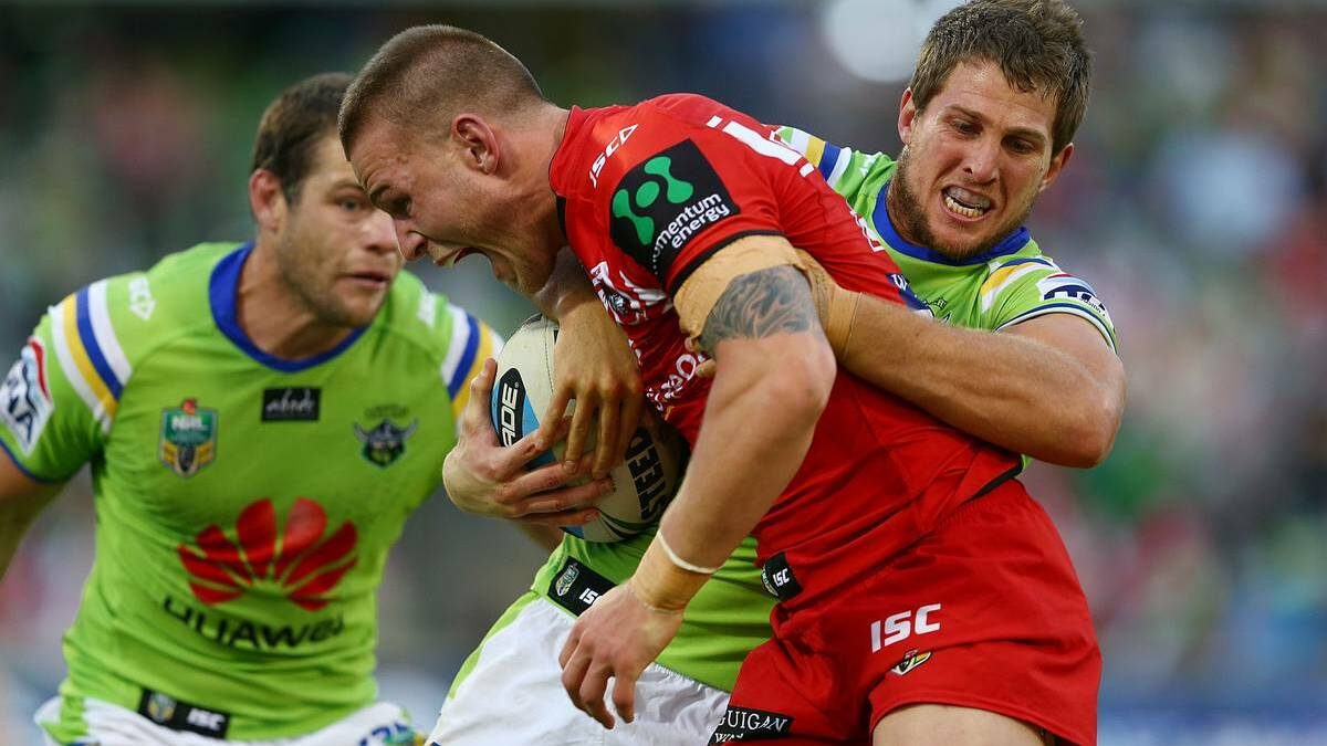• Dragons centre Euan Aitken gets wrapped up by Canberra Raider Josh Hodgson on Saturday. Photo: Getty Images. 