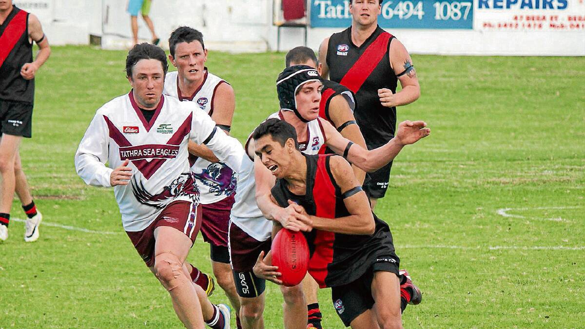 • Bomber Marty Scott-Thomas shapes to kick the ball clear as Sea Eagles defenders envelop him. 