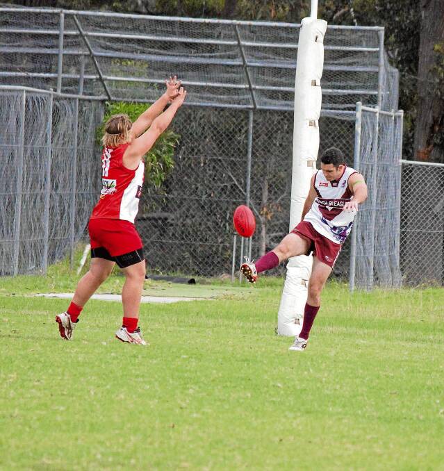 • Sea Eagle Matt O’Reilly kicks out under plenty of pressure from his Whaler opponent on Saturday. 
