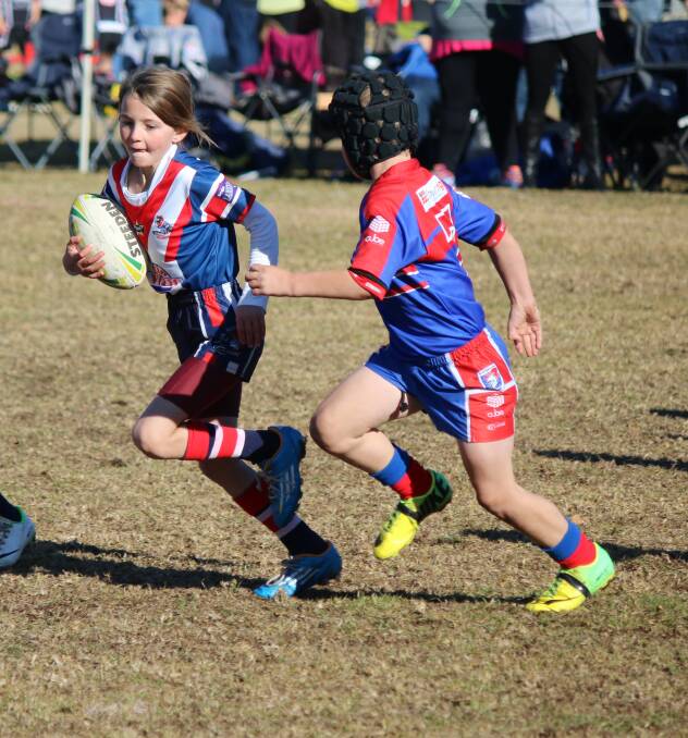 • McKinley Lucas drags a Knights defender wide during an under 8s match at the Group 16 minor league carnival in Bega on Saturday. 