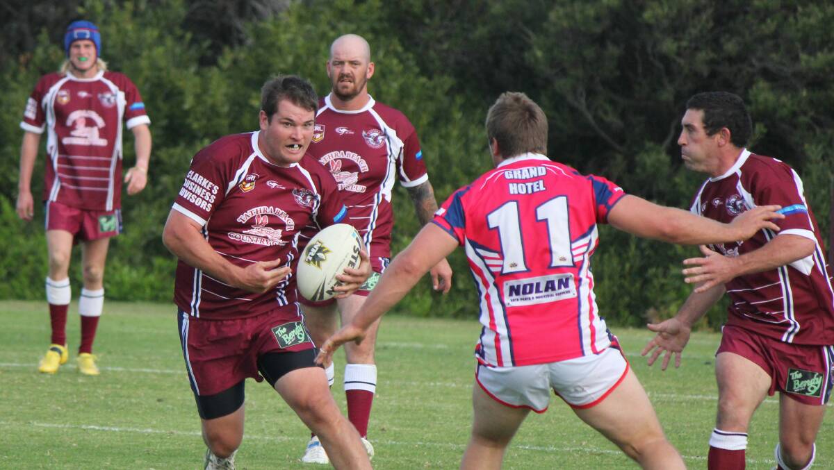 BEGA: Tathra Sea Eagles playing-coach Willie McDonald looks to sidestep Bega Roosters coach Ryan Apps on Sunday. 