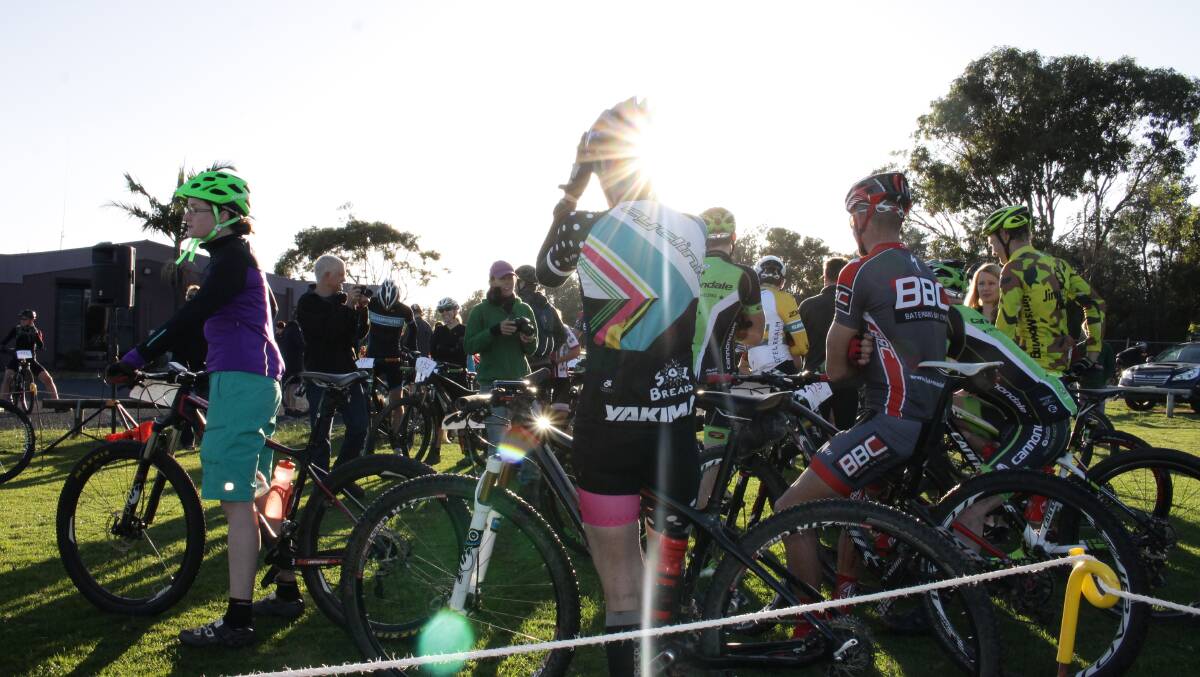 The sun peeks over riders for the start of the King Nelba 100km event at the Tathra MTB Enduro on Sunday. 